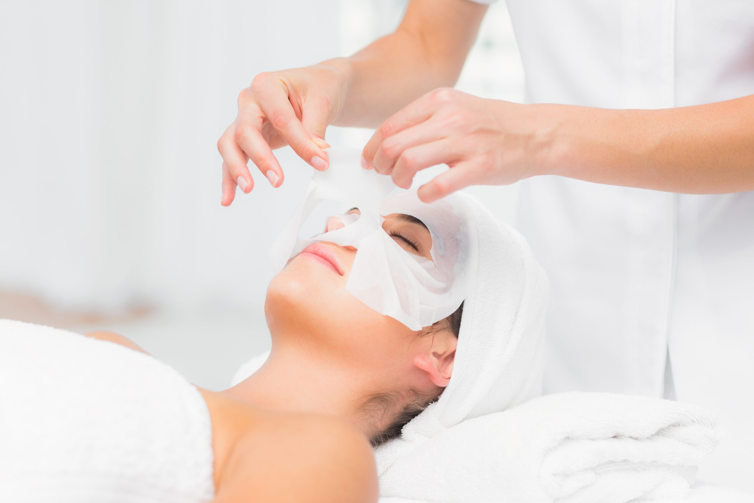 Beautiful brunette getting a facial treatment at the health spa